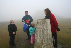 Carolyn and Co. inspect the trig point